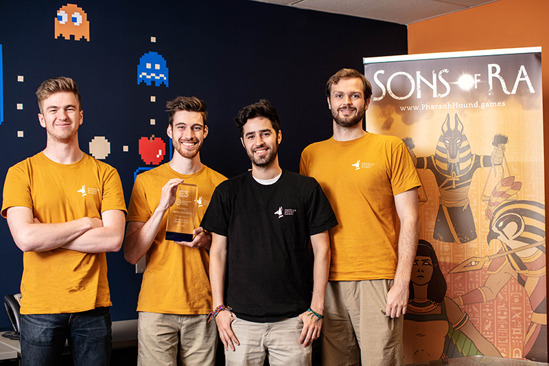 The Drexel students in Pharoah Hound Games pose with their E3 College Game Competition trophy. Left to right Joseph Brown, Jeff Mostyn, Michael Heffner and Mark Hurley. Photo credit: Charles Shan Cerrone.